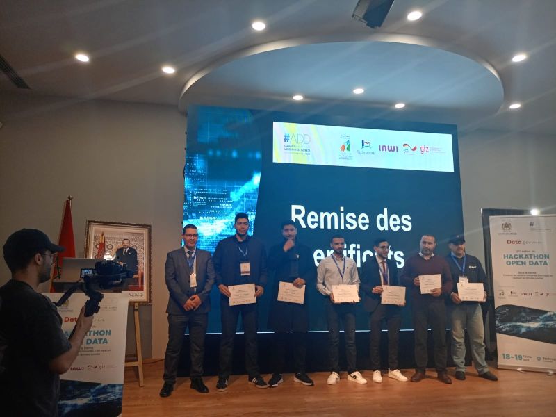 Open Data Hackathon 2025 award ceremony — Ahmed on stage with the certificates